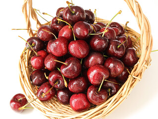 A basket of fresh fruit cherries on a white background