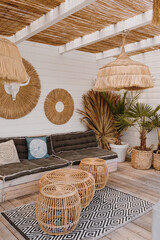 Furniture made of dried palm leaves, straw, rattan. Aesthetic bohemian interior design with straw and palms. Boho styled luxury resort hotel. Summer vacation holidays