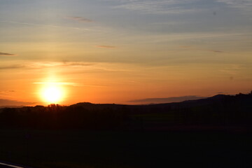 spring sunrise above dark hills