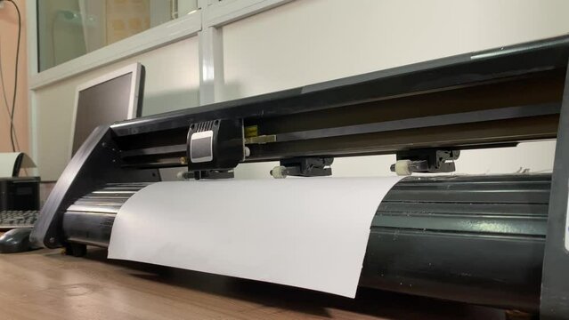 paper plotter. flatbed plotter for cutting. desktop computer. slow motion video. High-quality shooting in 4K format.