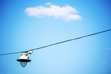 Obraz premium Lighting lantern on wire with blue sky background