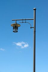 View of the street lamp against the blue sky