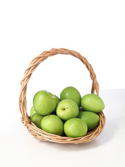 A basket of fresh fruit dates on a white background