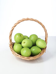 A basket of fresh fruit dates on a white background