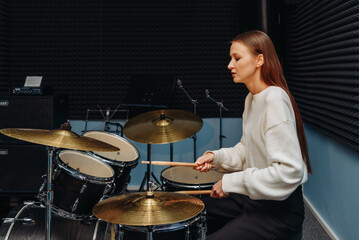 young woman playing drum set