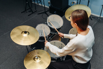 young woman playing drum set