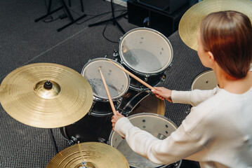 young woman playing drum set