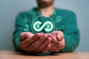Businessman holding 2050 infinity symbol with environment icon include green factory carbon reduction footprint credit and alternative energy for circular economy to sustainable development concept.