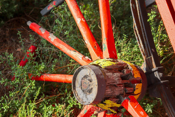 red spokes of old abandoned cart