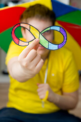 Autism infinity rainbow symbol sign in kid hand. World autism awareness day, autism rights...