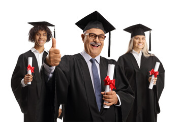 Graduation students and a mature man holding diplomas and gesturing thumbs up