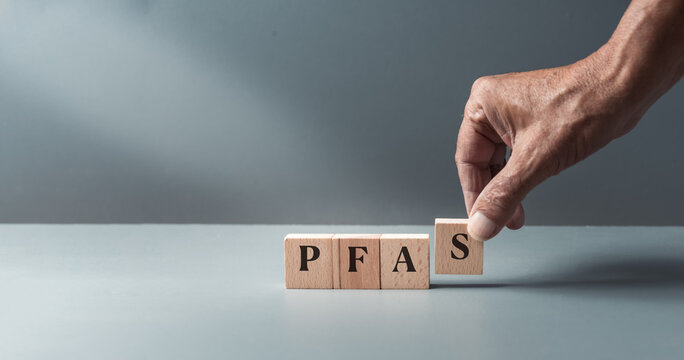 wooden blacks with pfas, per- and polyfluoroalkyl substances , concept of eternal or forever chemicals and pollution ,copy space .