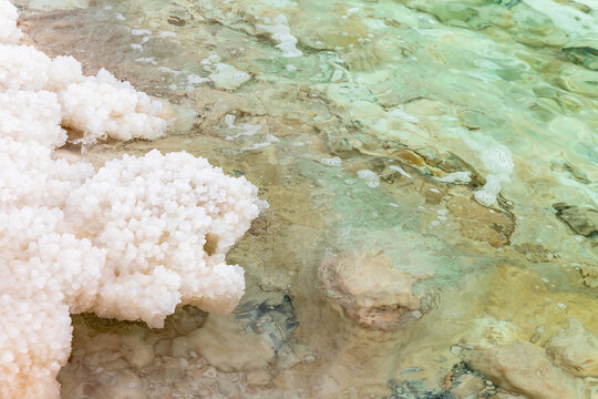 Deposits of mineral salts on the beach of the Dead Sea in Jordan. Horizontally. 