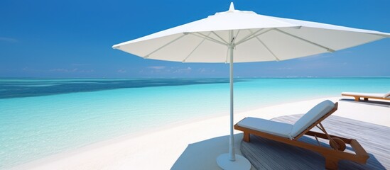 beautiful white parasol and sunbed in sea tropical Maldives romantic atoll island paradise luxury resort about coral reef amazing - obrazy, fototapety, plakaty