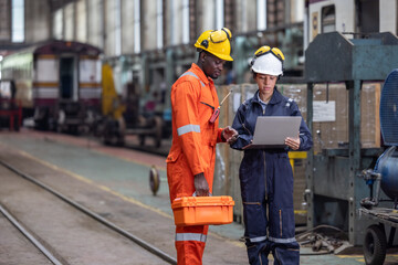 Engineer supervisor uses laptop for train diagnostics, maintenance, and CO2 reduction discussions.