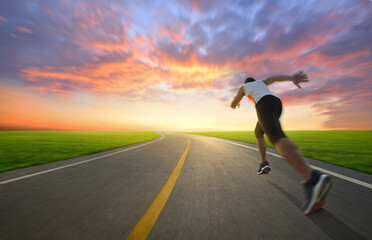 Action motion blur of a man running on country road with sunrise background...
