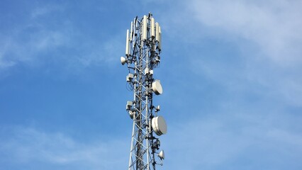 Cell phone telecommunication tower. Communication tower antenna on blue background. Antennas of mobile phone communication, television, internet, radio, on blue sky background. Beautiful 4K Footage.