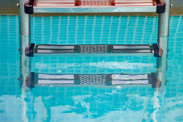 A metal ladder in the swimming pool, close-up view