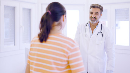 Female patient greeting the doctor in a medical clinic
