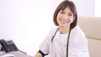 Female doctor smiling at camera in clinic