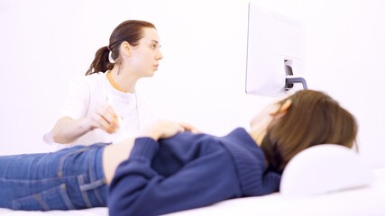Doctor performing an ultrasound on a woman in the clinic