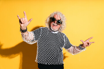 Funny senior man portrait with hard rock clothing style on cut-out background