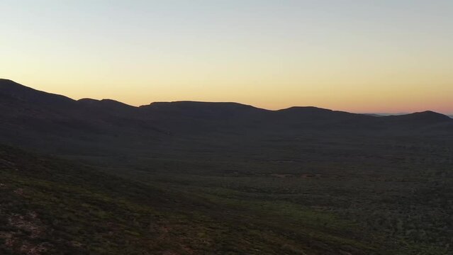 Colourful sunrise aerial panorama of Wilpena Pound rock formation in Flinders ranges.
