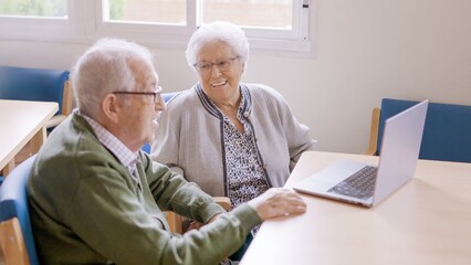 Senior people smiling during video call from a nursing home