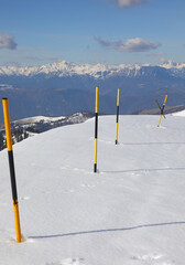 Black and yellow snow markers also called snow stakes