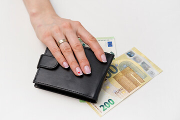 Woman takes money from a man wallet. Barracuda takes paper banknotes stolen from some person. Family financial literacy, loans, savings and taxes. Cash machinations, unplanned expenses, Euro currency
