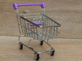 mini shopping cart on a beige background