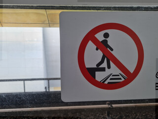 sign prohibiting walking or crossing on MRT tracks.