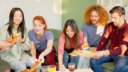 Friends smiling eating pizza together at home