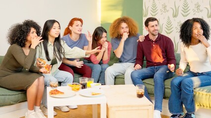 Group of friends at home watching a game on TV