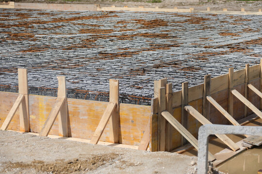 construction of building foundation with reinforced concrete pouring on construction site