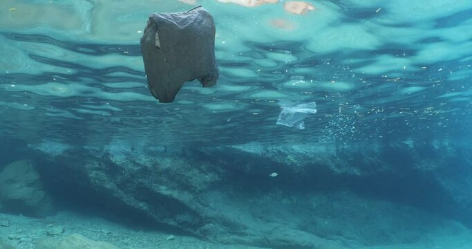 pollution underwater plastic material in the ocean plastic bag reflection on the surface