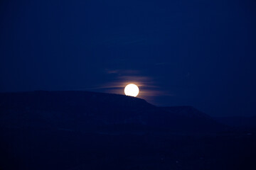 Full moon over the mountain range at night. Full moon photos in dark night.