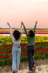 Joy in the flower field. Sunset on a flower field. girls in a flower field