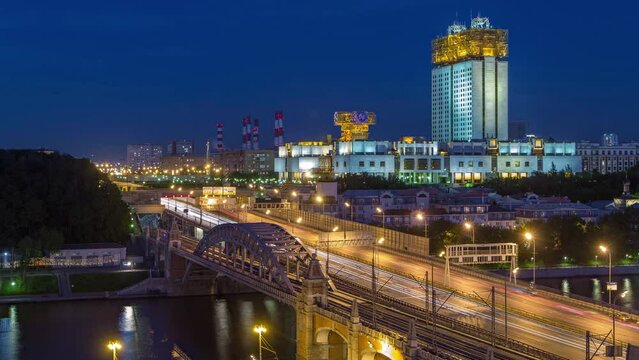 Evening view at the Russian Academy of Sciences day to night transition timelapse and Novoandreevsky Bridge over the Moscow River. Aerial view from rooftop after sunset