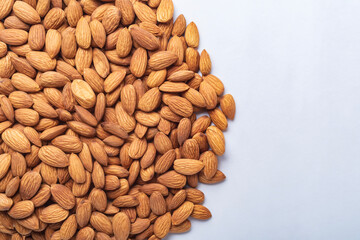 Top view of almonds on white background with copy space