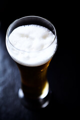 Glass of beer on dark background. Copy space.