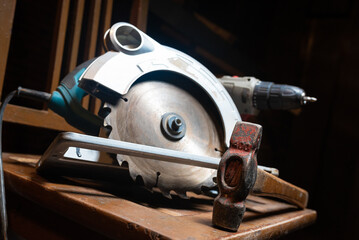 Circular saw, construction tools and wooden boards close up background. Woodwork. Construction...