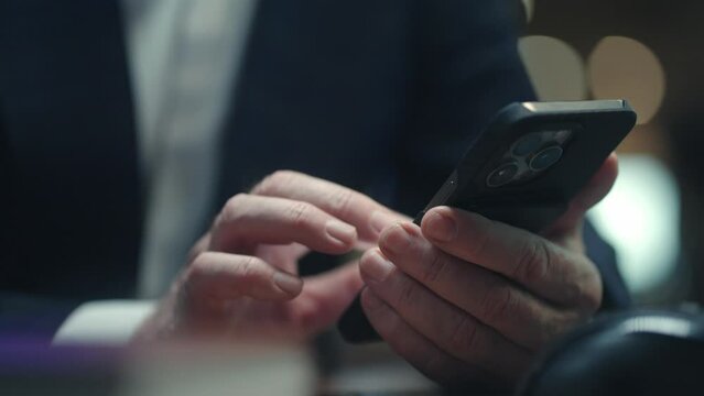 Camera view of man's hands holding smartphone. Actively typing message or text to someone. Chatting online. Remote communication. Male tapping his fingers on touch screen. Technology concept.