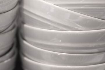 Stacked white bowls in the kitchen.