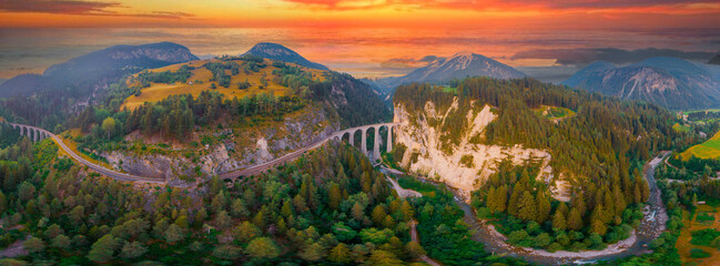 Aerial view of Train passing through famous mountain in Filisur, Switzerland. Landwasser Viaduct...