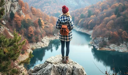 Deurstickers Serene autumn lake view with a young adult standing on the edge © volga