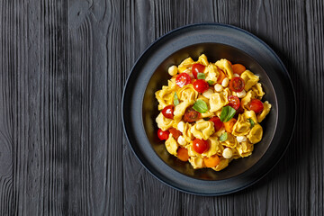 tortellini salad with tomatoes, mozzarella in bowl