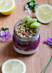 Strawberry and yogurt parfait topped with matcha granola in a jar and healthy oatmeal tart shell with raspberry jam with chia seeds 