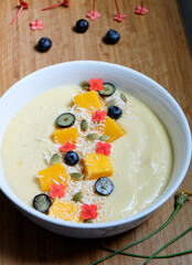 Pina colada inspired smoothie bowl made from pineapple, passion fruit, banana, lime and oat coconut...