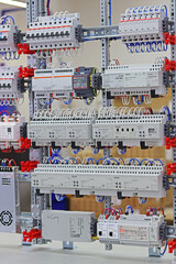 An electric switchboard with modules for protection and control of electrical loads, mounted on din...